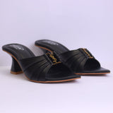 Black high-heeled sandals with a gold chain detail on a white background