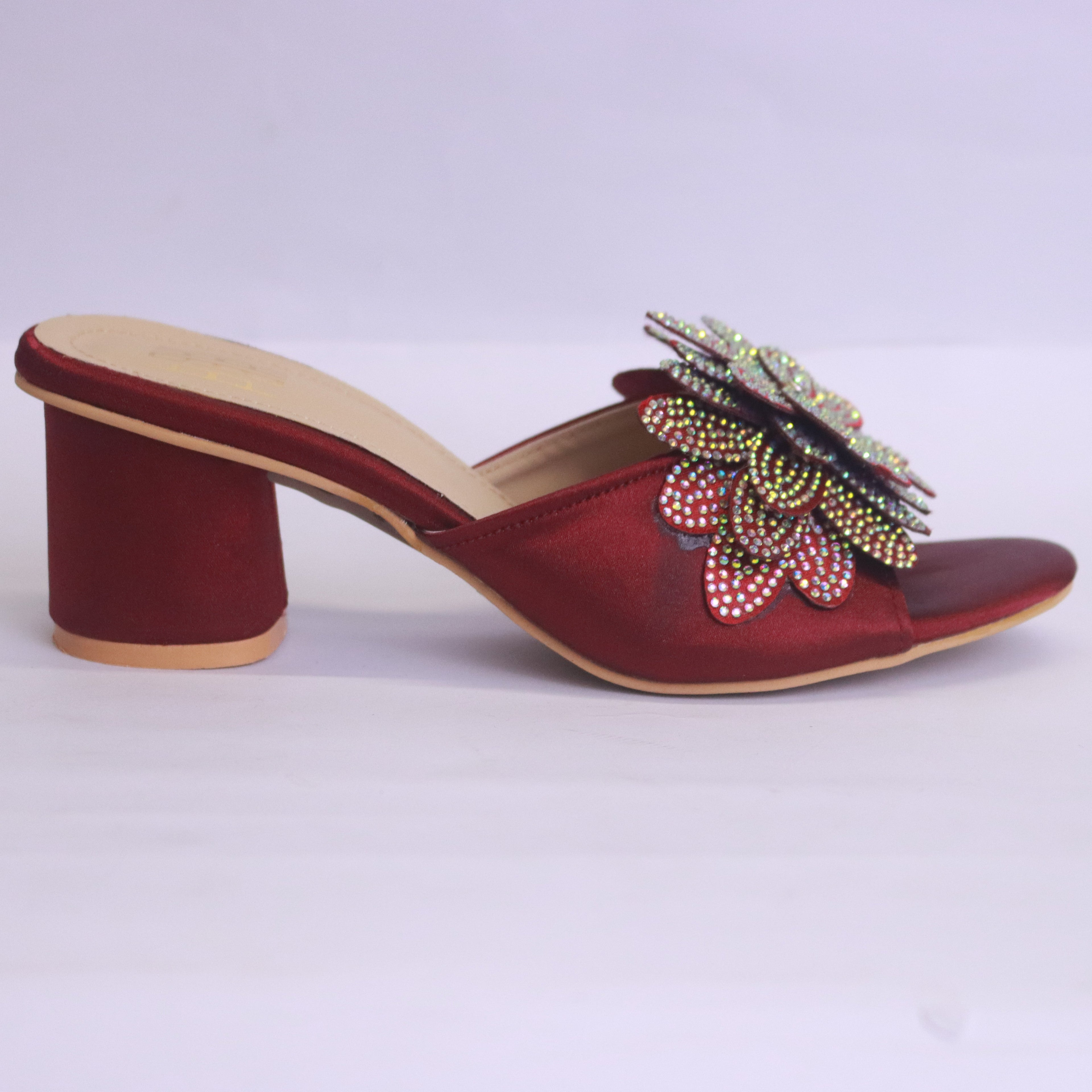 Black sandals with decorative flowers on a white background