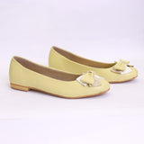 Pair of light yellow flat shoes with bow details on a white background